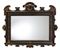 AN ITALIAN PAINTED AND PARCEL-GILT MIRROR