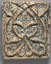 A GHAZNAVID SHARPLY MOULDED GREEN GLAZED POTTERY TILE  