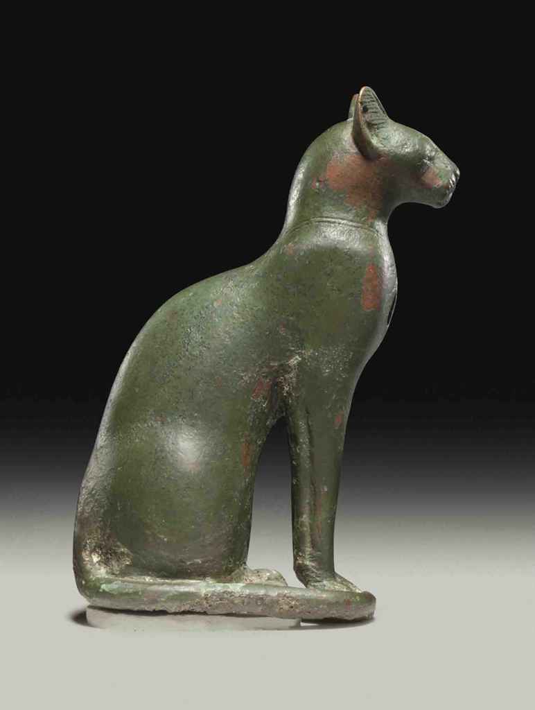 AN EGYPTIAN BRONZE CAT , THIRD INTERMEDIATE PERIOD, DYNASTY XXIXXVI, CIRCA 1069664 B.C