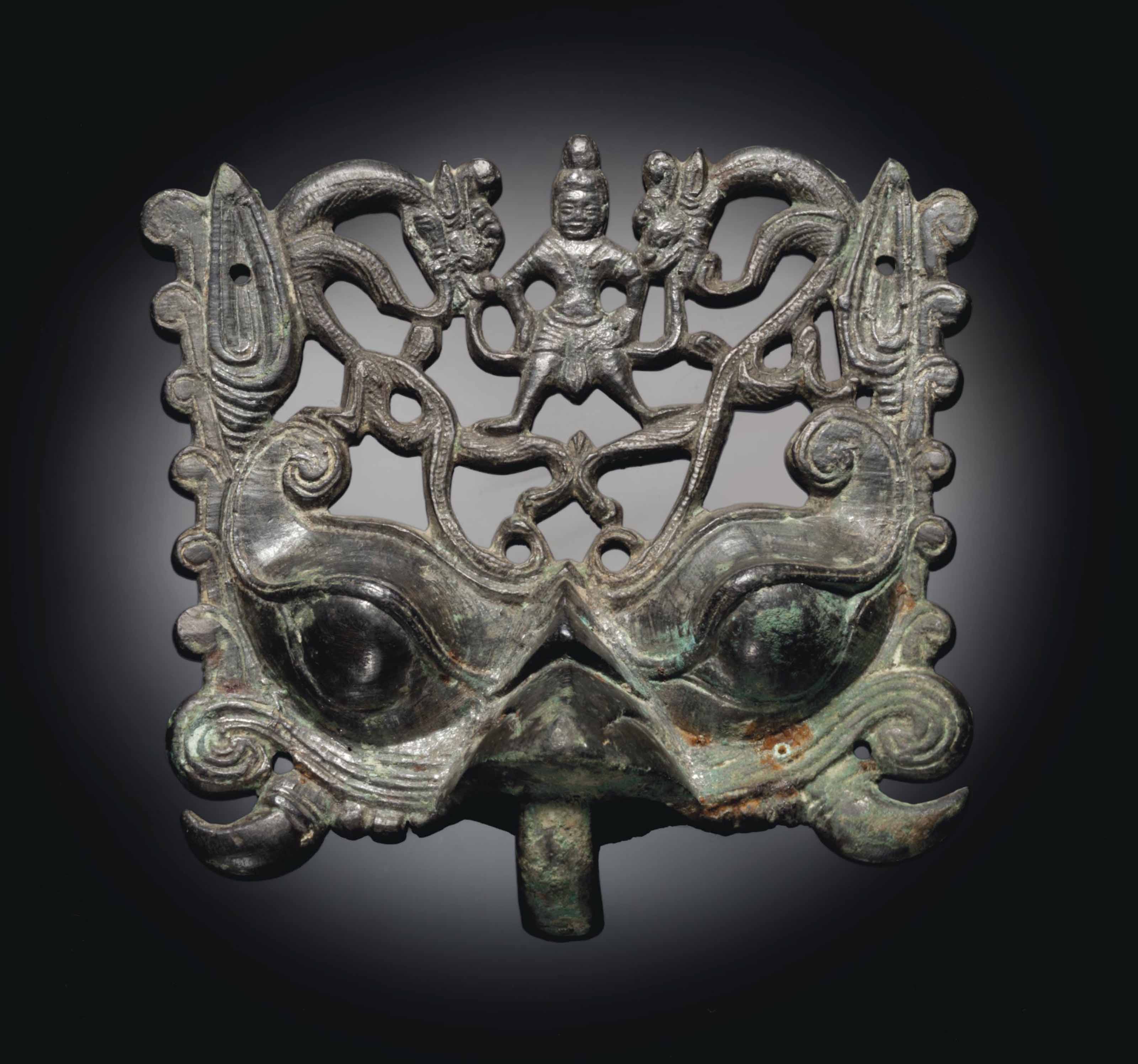 A RARE BRONZE OPENWORK TAOTIE MASK FITTING , NORTHERN WEI DYNASTY, 5TH
