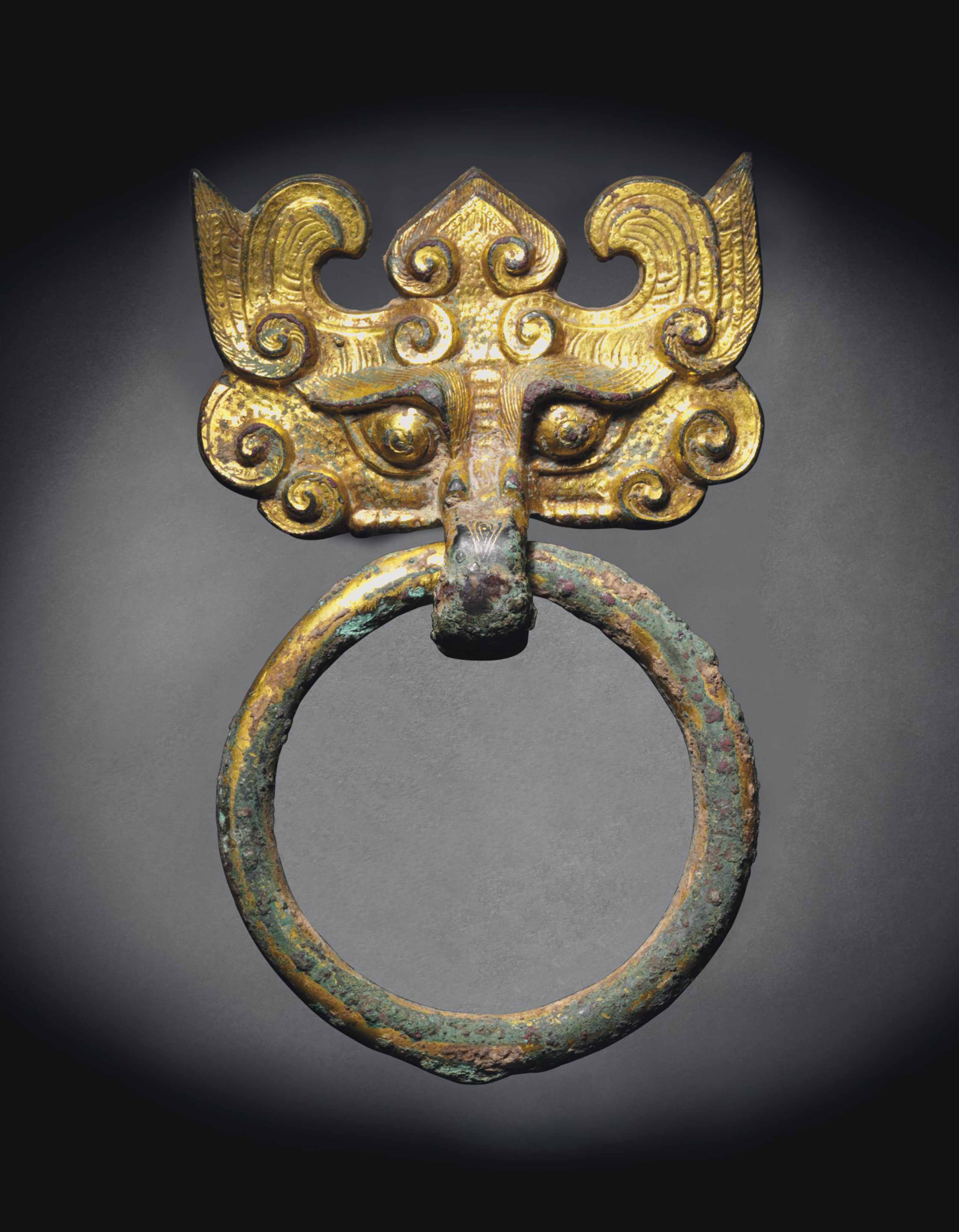 A GILTBRONZE TAOTIE MASK FITTING WITH LOOSE RING HANDLE , HAN DYNASTY