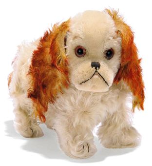A STEIFF STANDING MUSICAL CHARLY, (1322,03), white mohair, brown tipped mohair tail and ears, brown and black glass eyes, black stitching, swivel head, pressure-operated musical mechanism and FF button with remains of red cloth tag, circa 1929 --10¾in. (27.5cm.) long (slight thining)