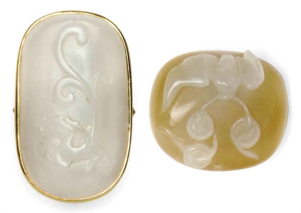 A SMALL CHINESE WHITE JADE PLAQUE MOUNTED AS A RING AND A SM...