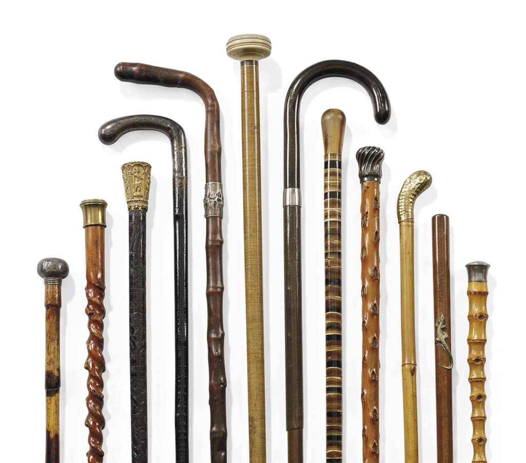 A GROUP OF TWELVE WALKING CANES INCLUDING A SPANISHCOLONIAL GILTMETAL