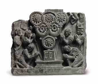 a_green_schist_relief_of_the_triratna_adored_gandhara_2nd_3rd_century_d5472974h.jpg