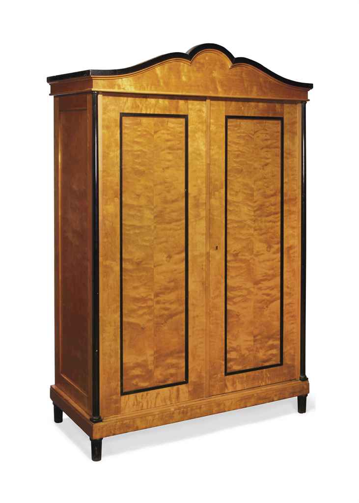 A BIEDERMEIER EBONISED AND BIRCH ARMOIRE