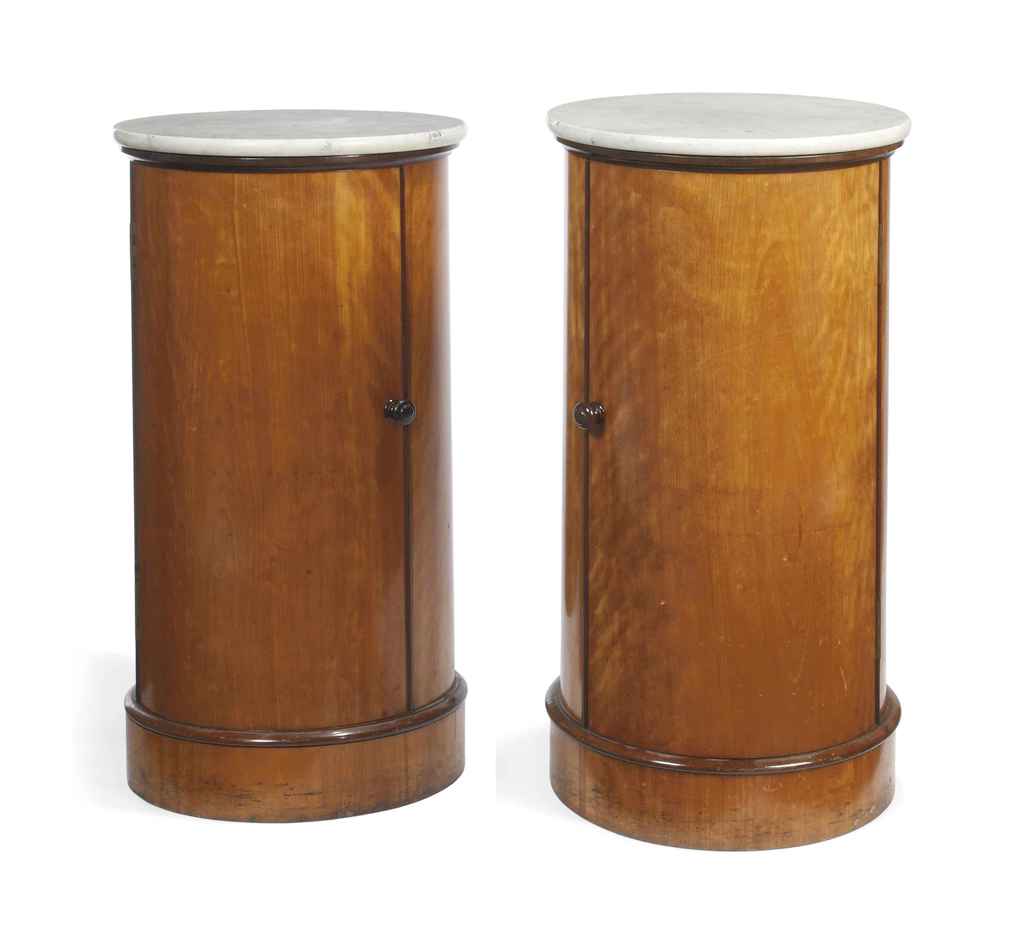 A PAIR OF BIEDERMEIER BIRCH AND AMARANTH CYLINDRICAL CUPBOARDS