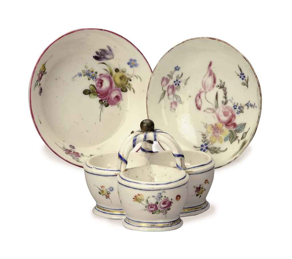 A FRENCH SOFTPASTE PORCELAIN SALT CELLAR AND TWO CONTINENTAL SAUCERS