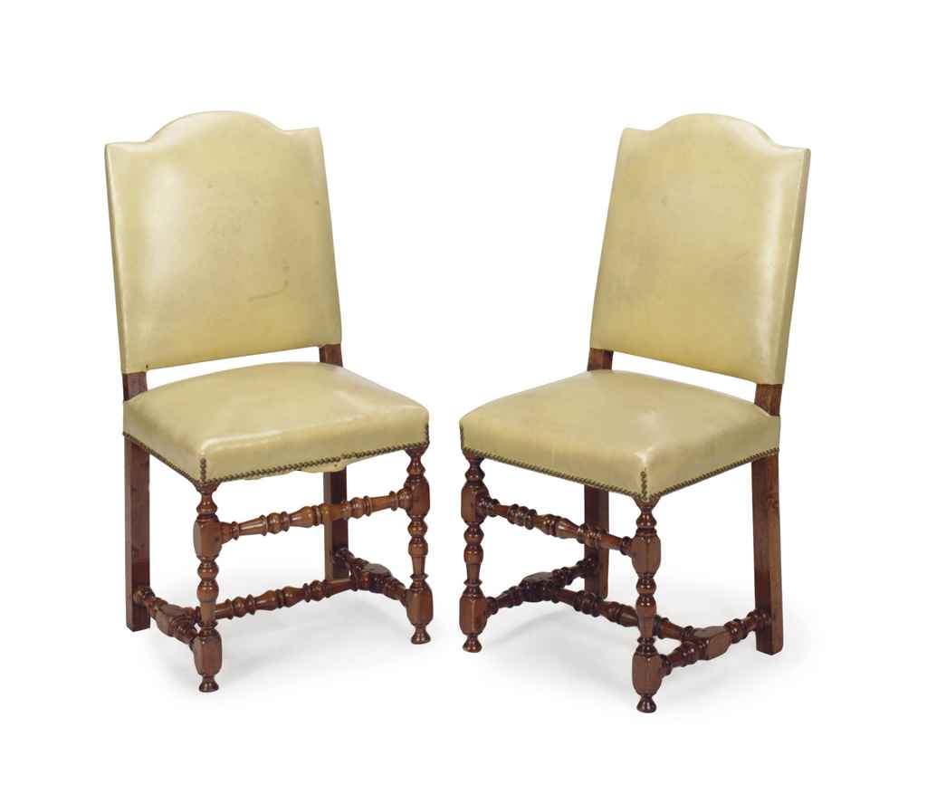 A SET OF SIX WALNUT AND LEATHER UPHOLSTERED DINING CHAIRS