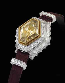 PIAGET. A LADY'S MAGNIFICENT, IMPRESSIVE, VERY RARE AND POSSIBLY UNIQUE 18K WHITE GOLD AND DIAMOND-SET HEXAGONAL WRISTWATCH WITH BROWN DIAMOND-SET CONCEALED DIAL 