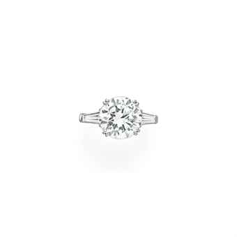 Lot 135 A DIAMOND RING Set with a circular-cut diamond, weighing approximately 5.46 carats, flanked on either side by a tapered baguette-cut diamond, mounted in platinum round brilliant engagement ring with baguette, 5 carat engagement ring, diamond ring christie's