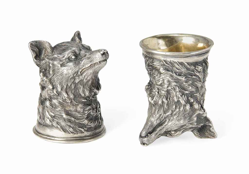 A pair of small cast German silver stirrup cups in the form ...