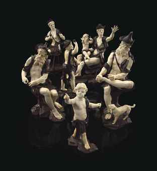 A GROUP OF SIX CARVED IVORY AND WALNUT FIGURES OF BEGGARS  