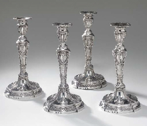 A set of four George III silver candlesticks