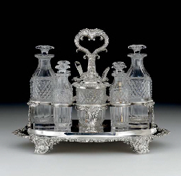 A GEORGE IV SILVER AND GLASS CRUET STAND