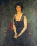 Portrait of Dorothy Duveen, three-quarter length, seated on a red chair