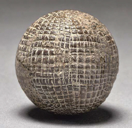 A HAND-HAMMERED GUTTY GOLF BALL  