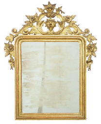 A CONTINENTAL CARVED GILTWOOD WALL MIRROR