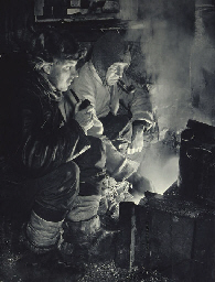Meares and Oates at the blubber stove, 26 May, 1911; Capt. Scott writing up his Journal in the Winter Quarters Hut, 7 October, 1911 