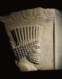 AN ACHAEMENID STONE RELIEF FRAGMENT  