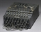 ENIGMA-- Calculating Machine. A three-rotor Enigma enciphering machine, number A-957, with electric core end stamped B above bulb board, raised 'QWERTZ' keyboard with crackle black painted metal case (some restoration), three division window flap over rotors and concealed plugboard in the front with twelve patch leads, in carrying case, circa 1939. 10 in (26cm) wide, also with metal label Chiffriermaschinen Gesellschaft Heimsoeth und Rinkew on  the inside of the lid -0.5in (2.5cm) high