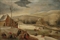 A winter landscape with the Holy Family warming themselves by a fire, skaters and sledgers on a frozen river beyond 