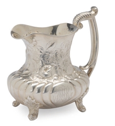 AN AMERICAN SILVER WATER PITCHER REPOUSSE WITH FLOWERS