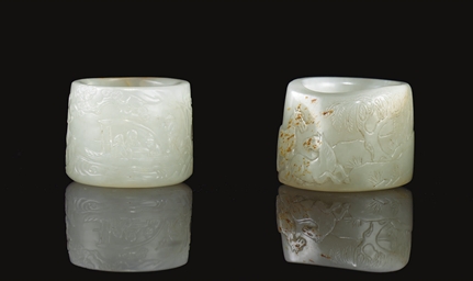 TWO WHITE AND RUSSET JADE THUMB RINGS