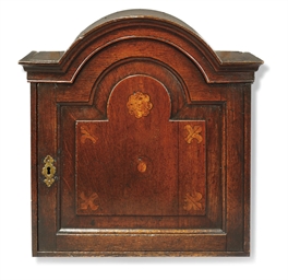 A GEORGE II OAK HANGING SPICE CUPBOARD