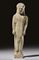 A GREEK TERRACOTTA KOUROS  