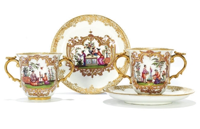 A PAIR OF MEISSEN TWO-HANDLED CUPS AND SAUCERS