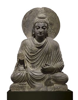 A gray schist figure of a seated Buddha  