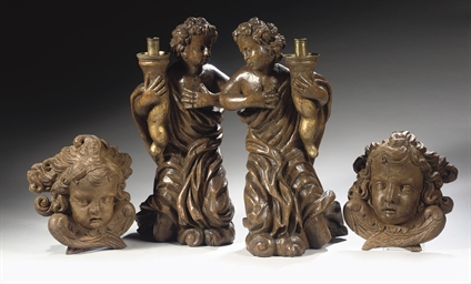 A PAIR OF PARCEL-GILT CARVED OAK FIGURES OF CANDLEBEARING AN...