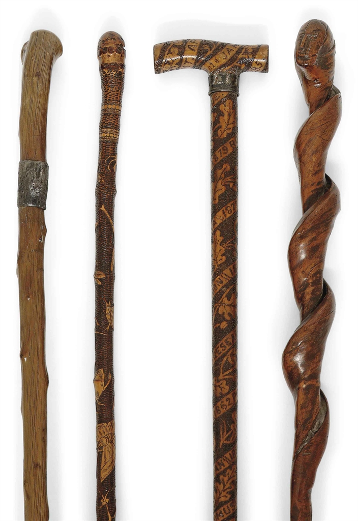 Four british carved wood walking sticks th century Four british carved wood walking sticks th century