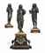 A FRENCH PARCEL-GILT BRONZE, ROUGE AND BLACK MARBLE THREE-PIECE FIGURAL CLOCK GARNITURE