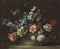 Roses, daffodils, hyacinths, anemones, fritillaries and other flowers in a woven basket on a stone ledge