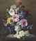 Roses, clematis, lavatera, and pansies in an urn