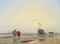 A coastal landscape with fisherfolk, a beached boat beyond