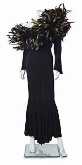 A BLACK JERSEY AND FEATHER-EMBELLISHED LONG-SLEEVED GOWN 