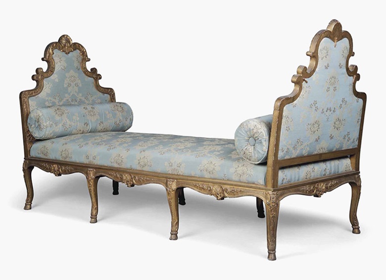 A French giltwood daybed, 19th century, of Regence style. The shield-shaped ends covered à chassis and carved with shells, acanthus and flowerheads, on cabriole legs and hoof feet, regilt. 45¾ in (116 cm) high; 87½ in (222 cm) wide; 32 in (81 cm) deep. This lot was offered in The Claudio Bravo Collection From the Artists Studio and Home, Morocco on 12 July 2016 at