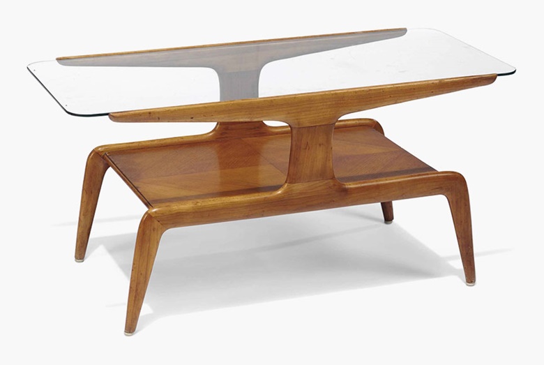 A stained and veneered beech two-tier occasional table in the style of Gio Ponti. Third quarter 20th century. 18½ in (47 cm) high; 37¾ in (96 cm) wide; 17¾ in (45 cm) deep. This lot was offered in Interiors on 20 July 2016 at Christie’s in London, South Kensington