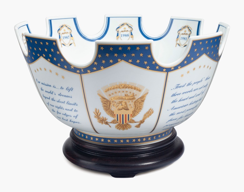 A Mottahedeh porcelain Chinese export-style presidential presentation monteith on wood stand. Modern, blue printed mark. The exterior richly gilded with panels of the Presidential seal alternating with quotes from President Reagan, the interior centred by the Presidential seal and eight shields dated for each year of the Reagan Administration, the underside inscribed, PRESENTED BY THE PRESIDENT