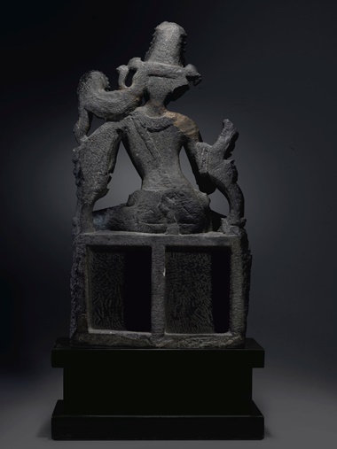 The back of the figure has been carved in deep relief, and the lotus throne that forms the work’s base has been hollowed out — a feature which, Coyle suggests, could have been intended to lighten the work