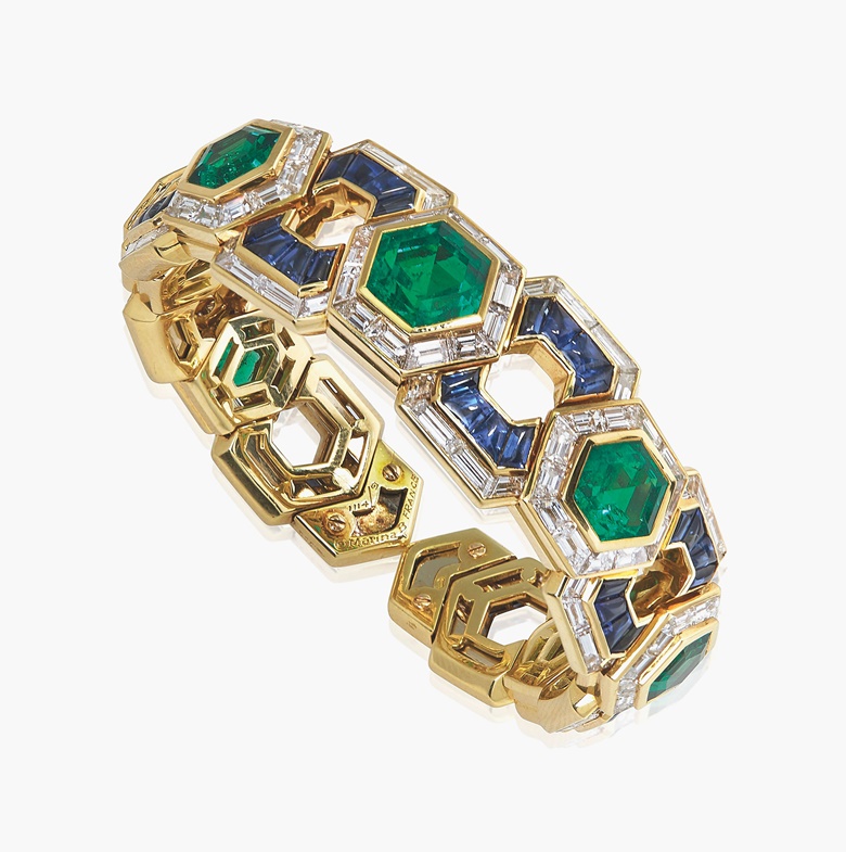 The unique emerald, sapphire and diamond ‘Exi’ bracelet, by Marina B. The expandable cuff bracelet composed of seven hexagonal step-cut graduated emeralds within a baguette-cut diamond surround, to the buff-top sapphire and diamonds spacers, 1989, 14.5 cm inner circumference, with French assay mark for gold. Signed and with makers mark for Marina B, no. 11149. Estimate CHF