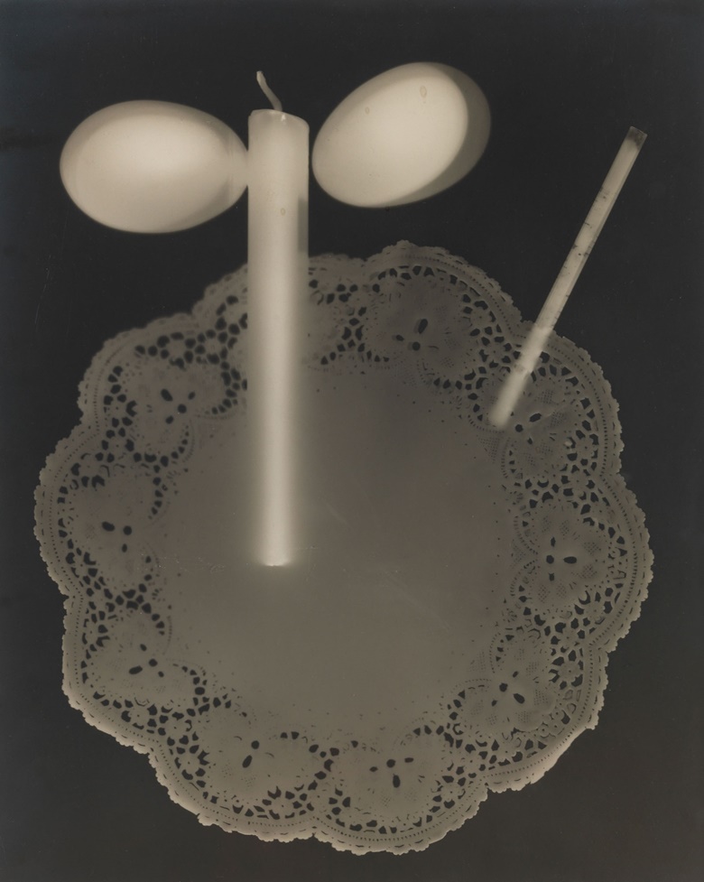 Man Ray (1890-1976), Rayograph, 1923. Unique gelatin silver print, mounted on card. Imagesheet 11¾ x 9½ in (29.9 x 24.1 cm). Mount 14¾ x 11 in (37.4 x 27.9 cm). Estimate $200,000-300,000. This work is offered in the Photographs Day Sale on 10 October at Christie’s in New York