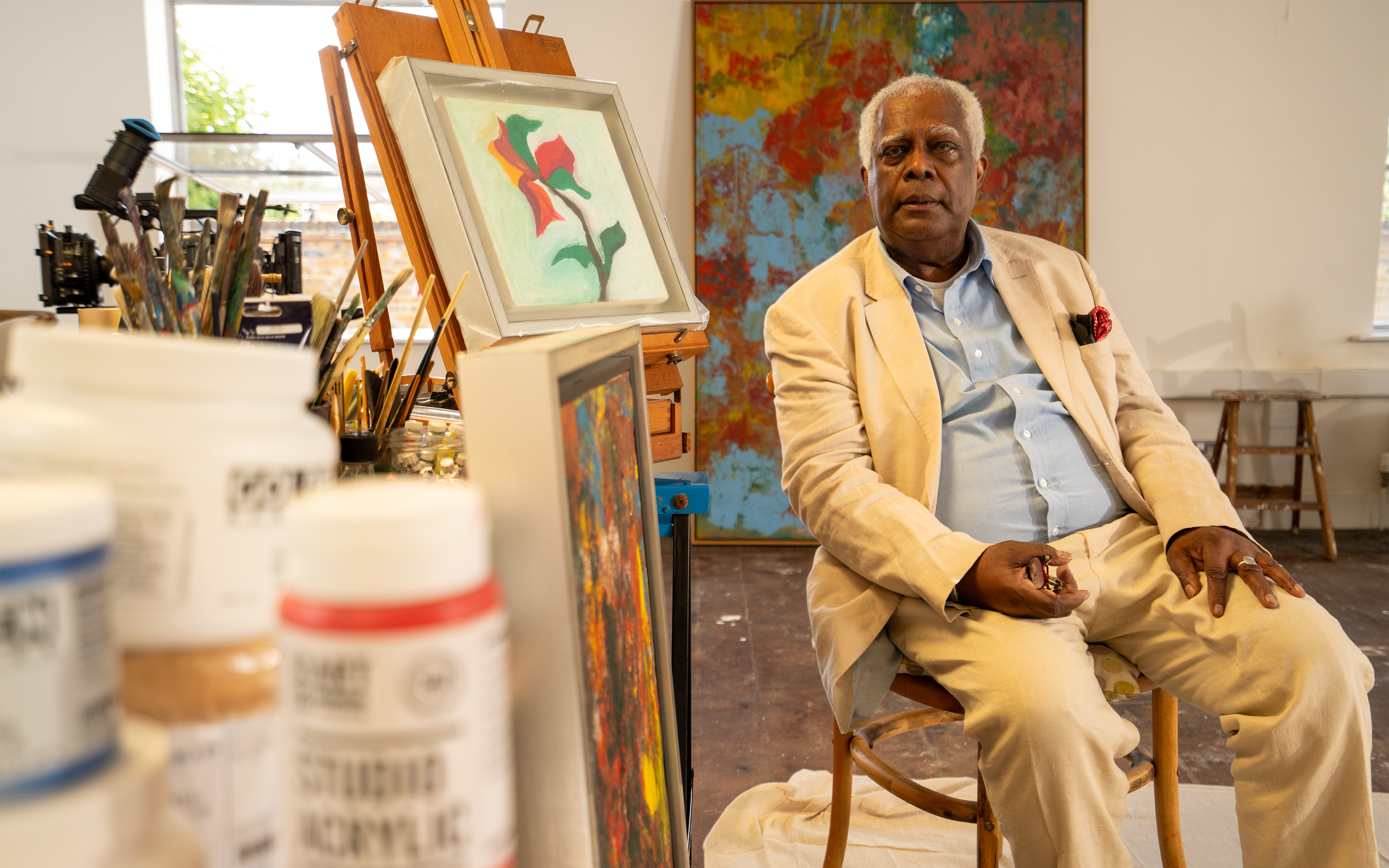 Winston Branch in his London studio, 2023. The Magic is in You, 1982-84 (detail, behind the artist), will be offered at Christie’s in London on 13 October 2023
