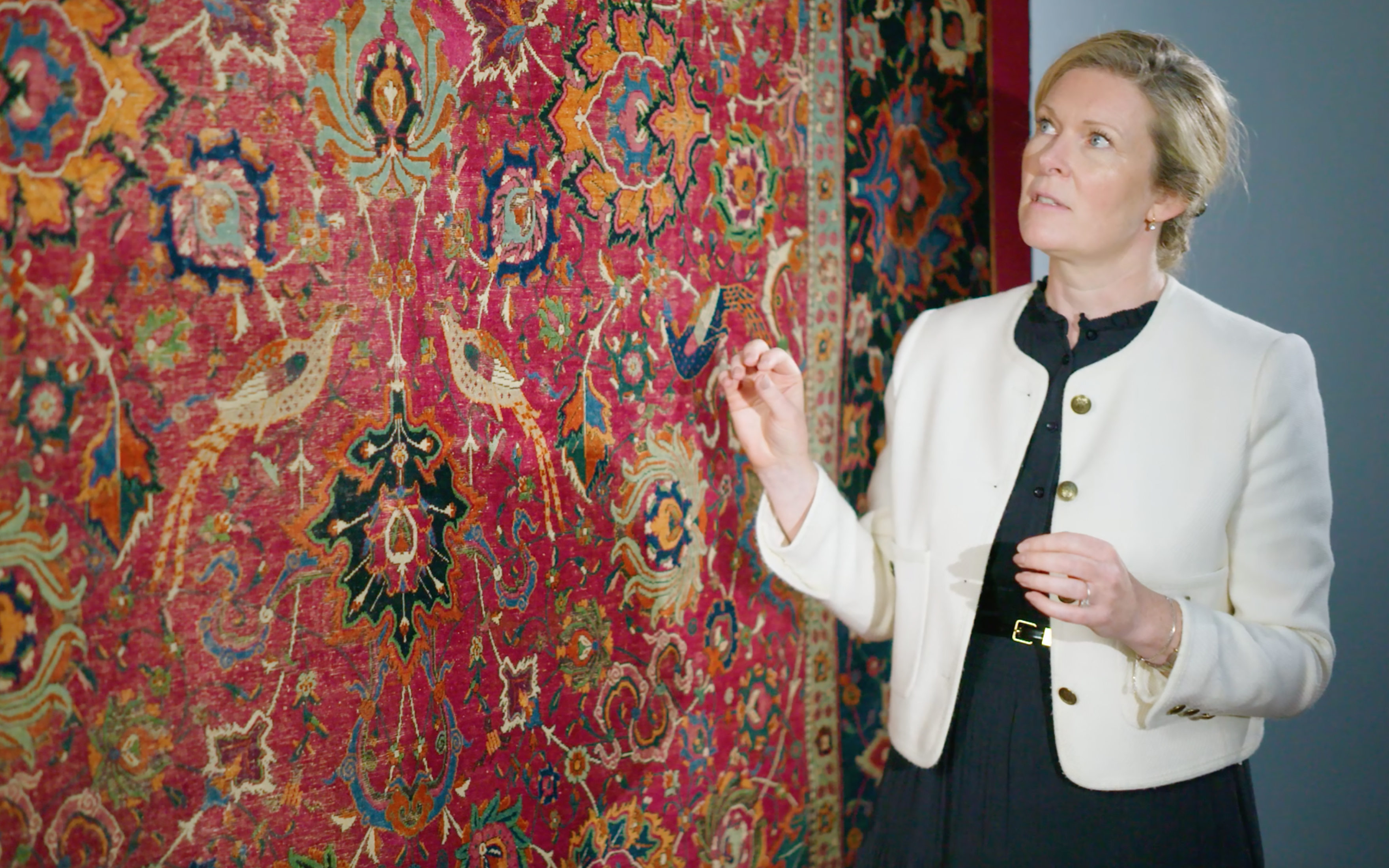 Specialist Louise Broadhurst with the Safavid red-ground 'Palmette and Bird' carpet (circa 1565-75)