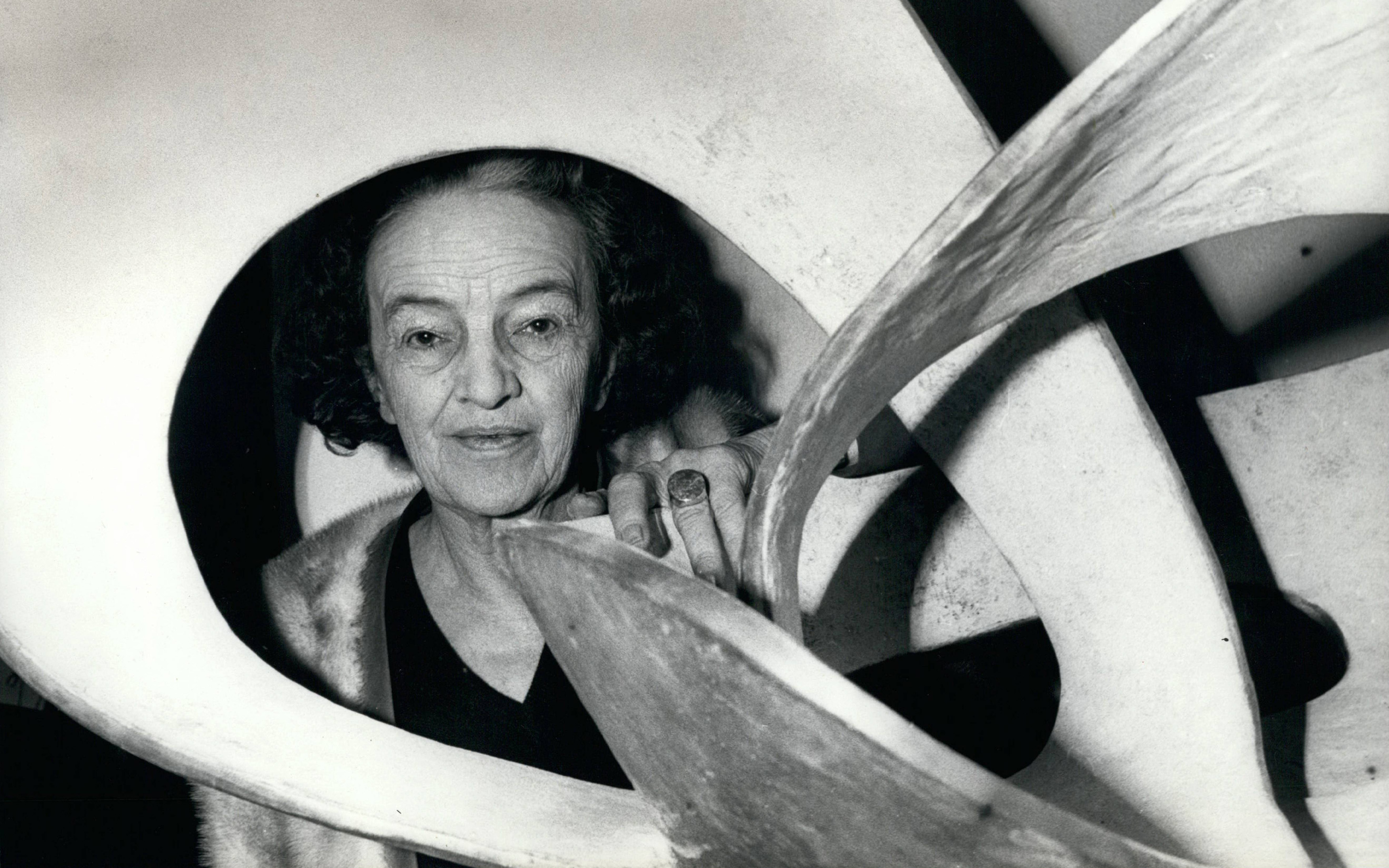 Barbara Hepworth photographed with Forms in Movement (Pavan), 1956-59, cast 1967, at her retrospective at the Tate Gallery, London, in 1968