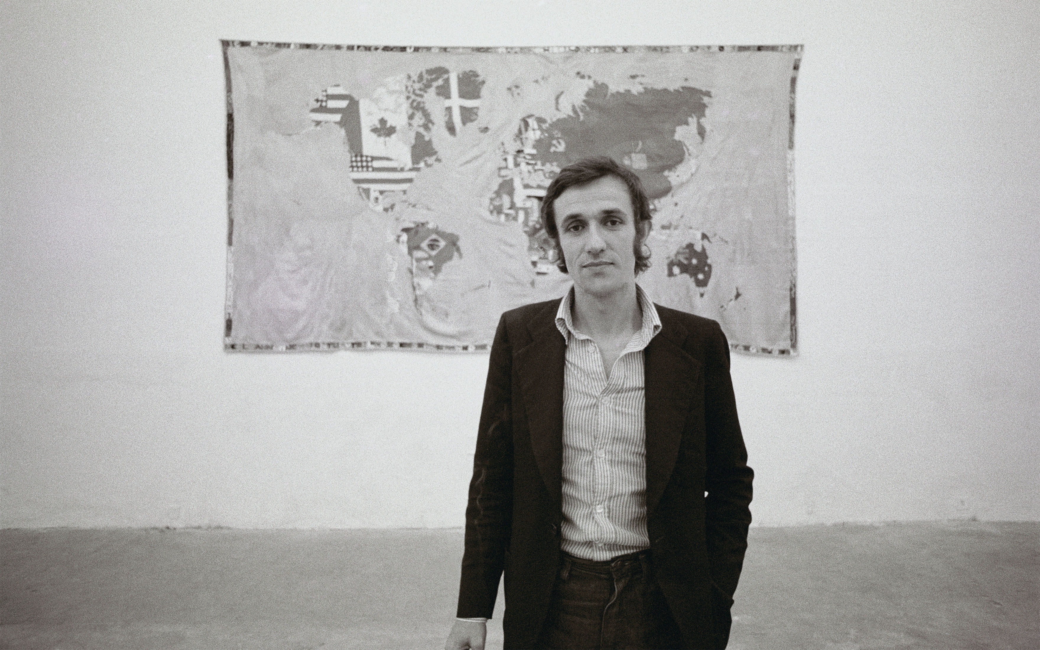 Alighiero Boetti pictured in 1973 in front of the first Mappa, which had been created in Afghanistan two years earlier