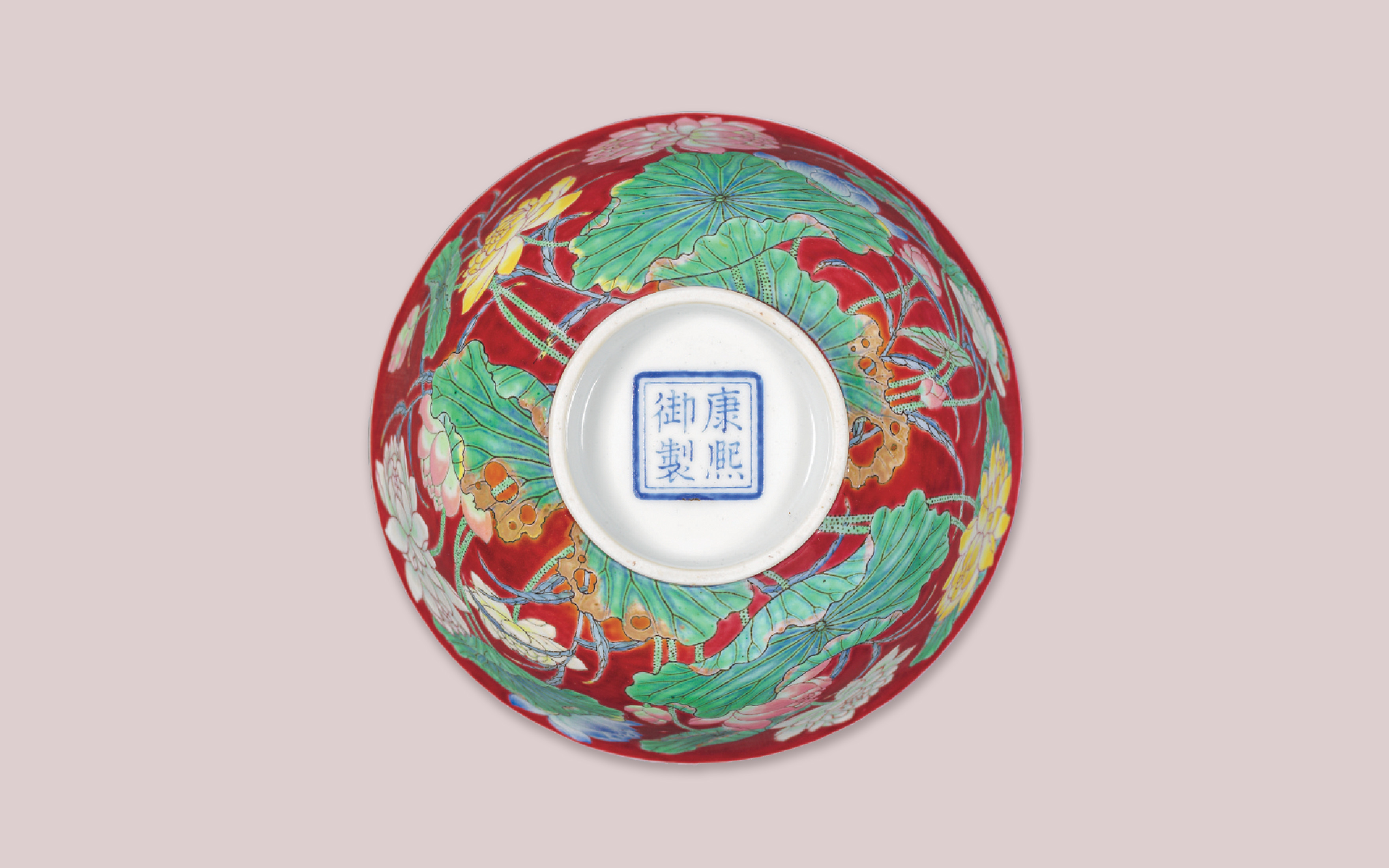 A Kangxi blue-enamelled four-character mark within a double square and of the period (circa 1722) from an Imperial ruby red-ground falangcai double lotus bowl, which sold for HK$87,200,000 on 27 November 2019 at Christie's in Hong Kong